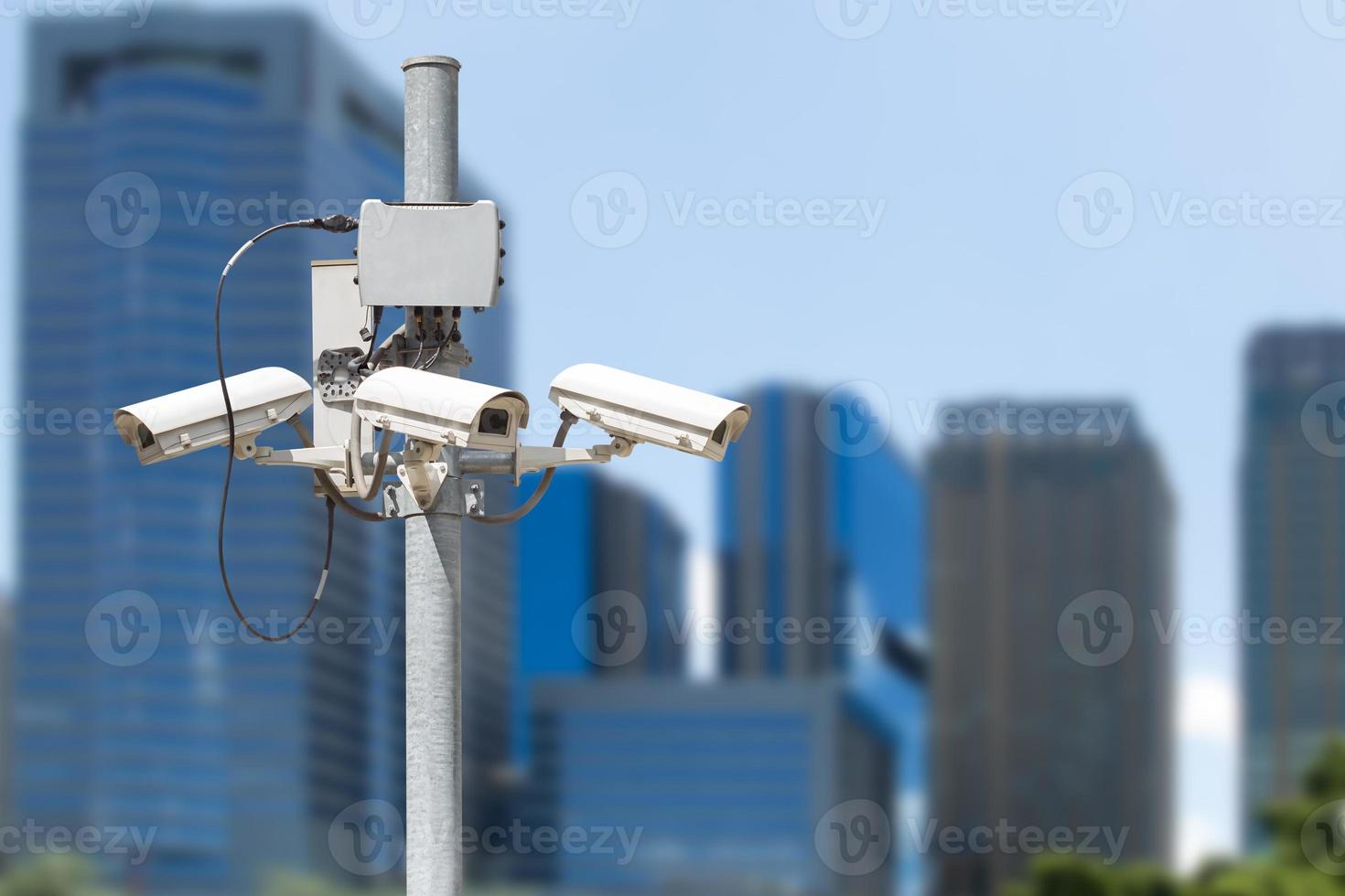CCTV pillar with the building in the city background photo