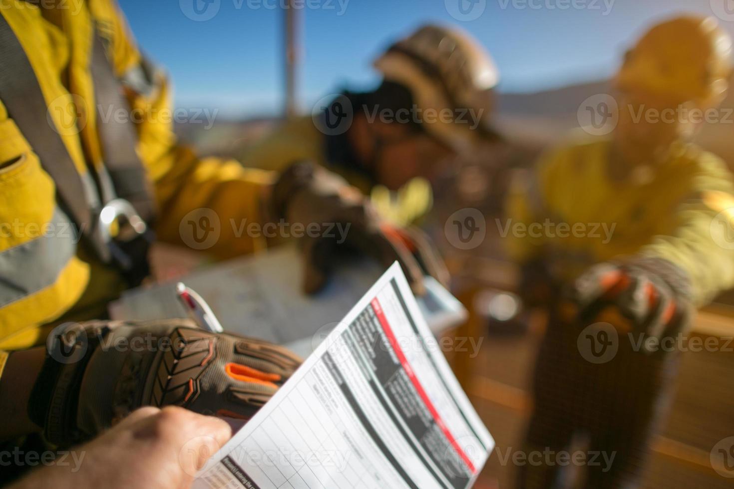 Construction workers signing off high risk working at heights permit photo