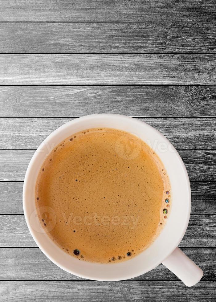 Hot coffee cup with clipping path top view on wood plank background photo