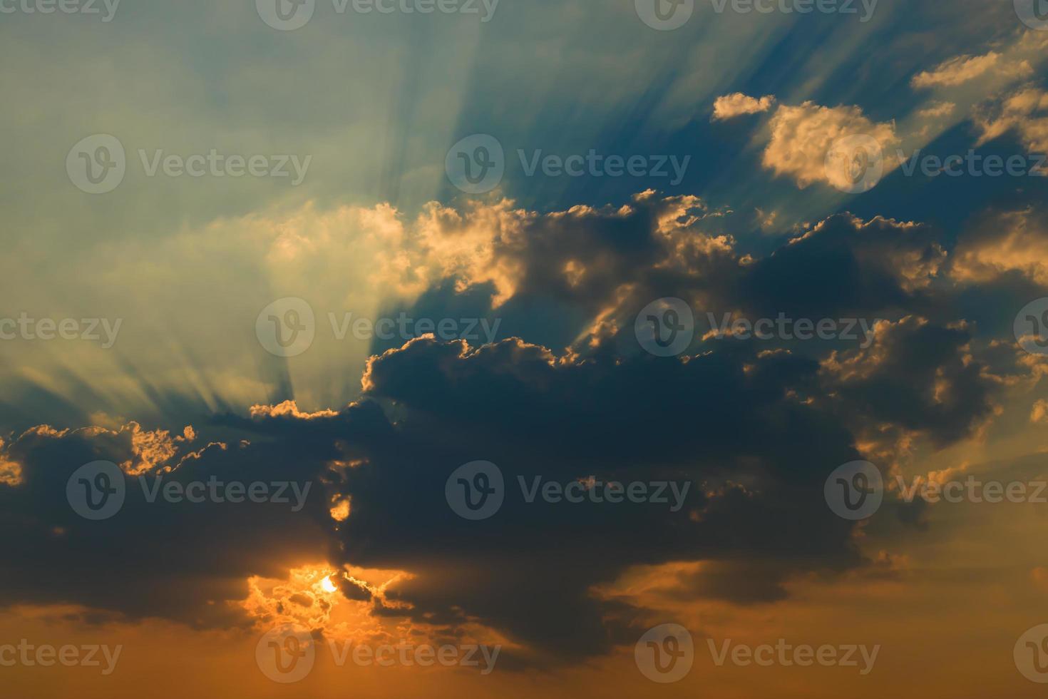 Beautiful sky with clouds and sun rays at sunset photo