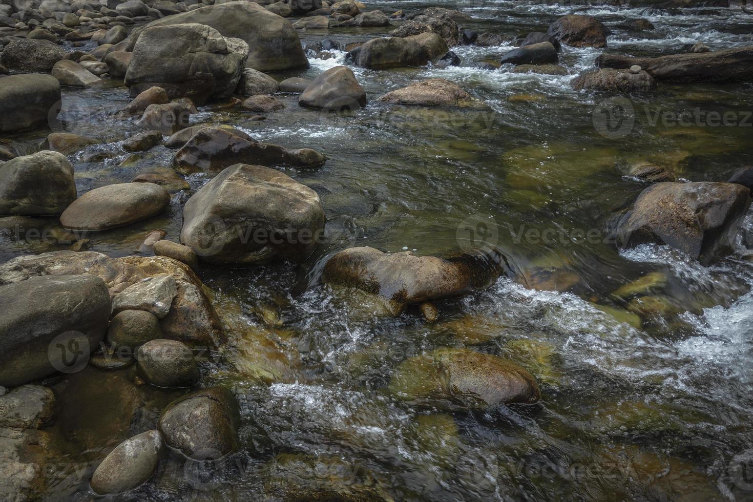 Diferencia de piedra ver a través del río claro. foto