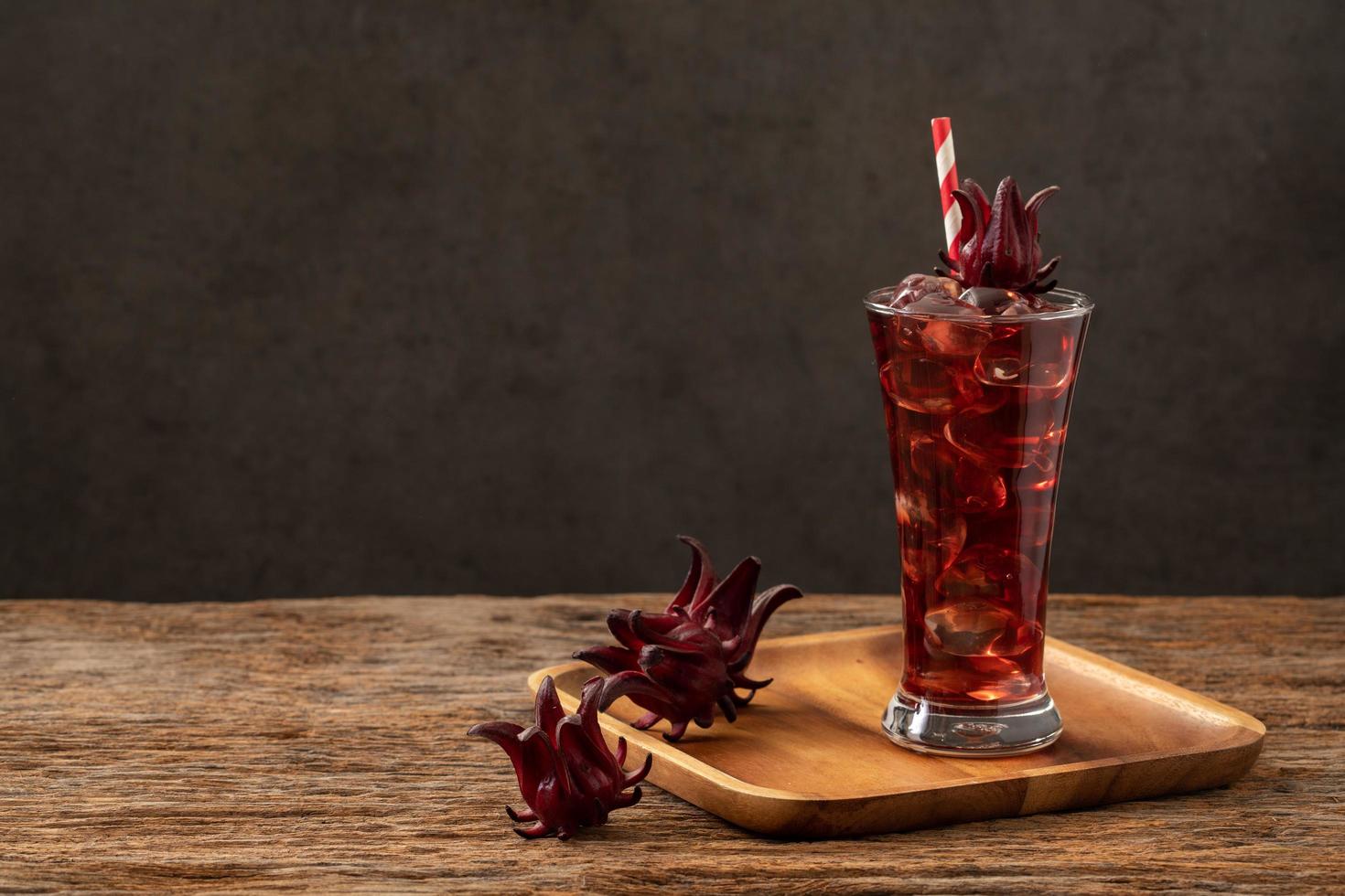 roselle clear glass with fresh roselle fruit on wooden table photo