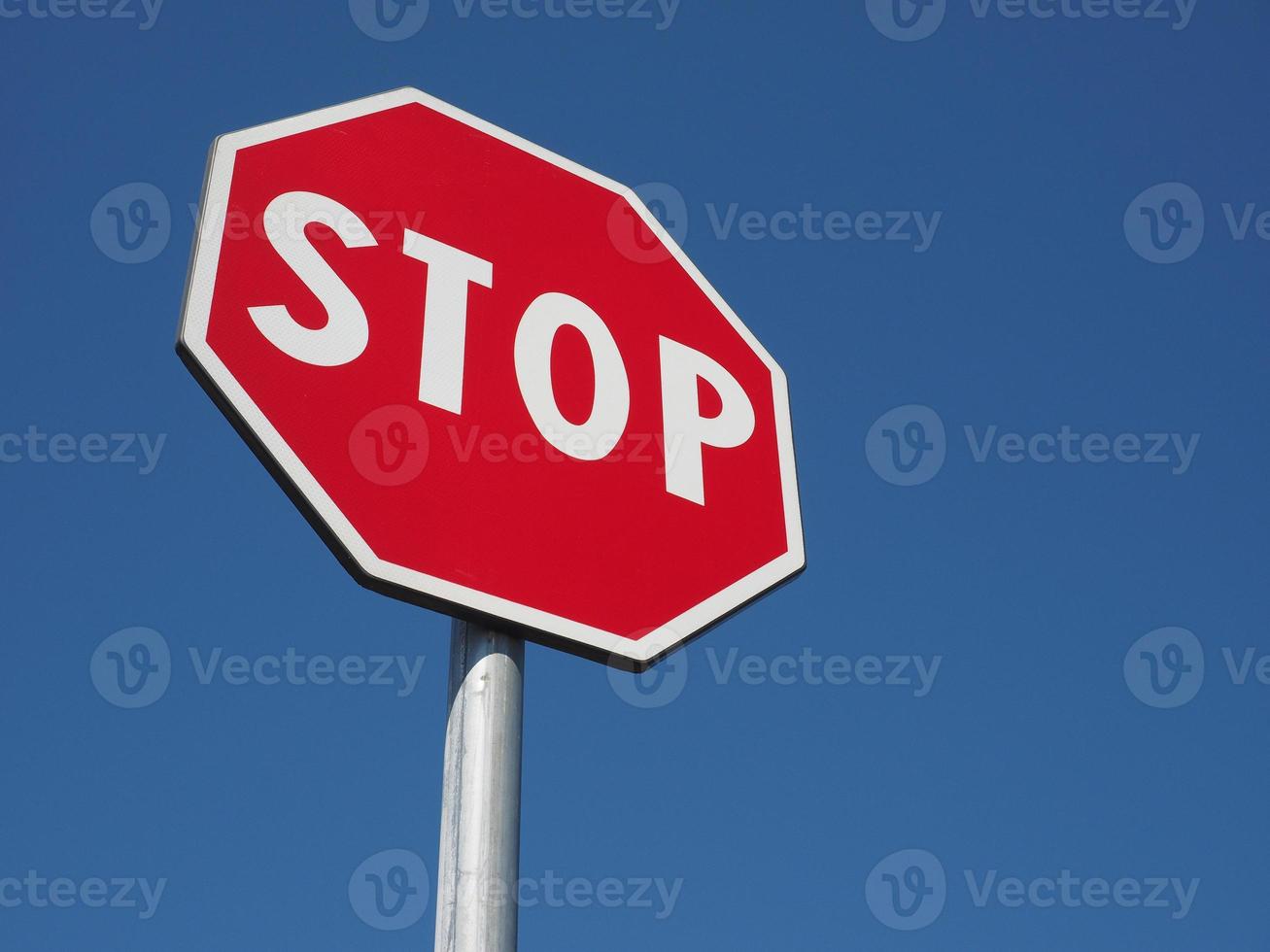 stop sign over blue sky photo