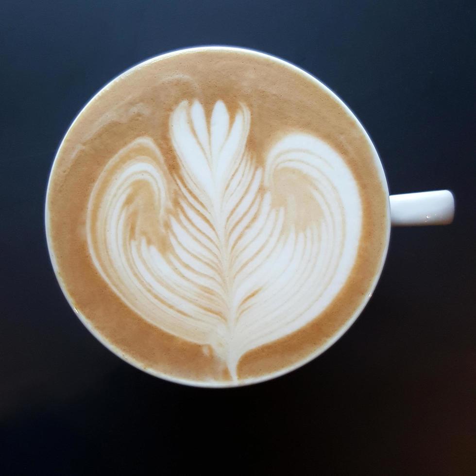 Top view of a mug of latte art coffee. photo