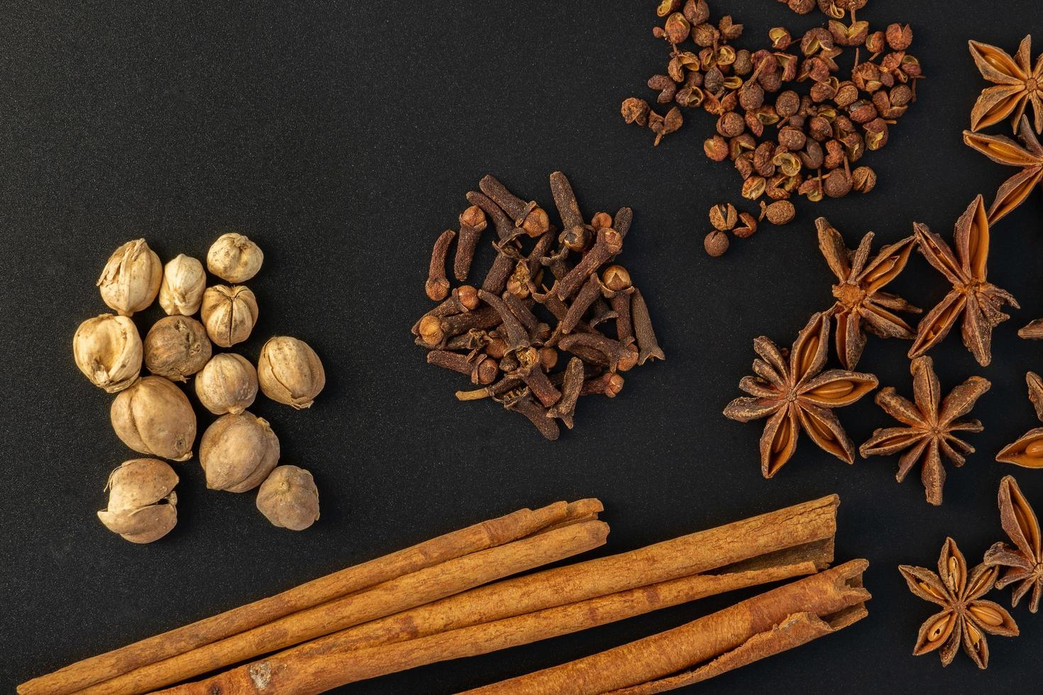 Assorted colorful spices on a black background. photo