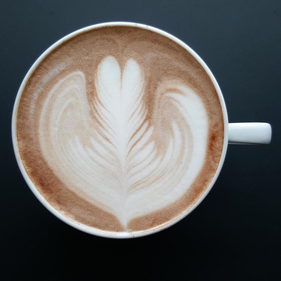 Top view of a mug of latte art coffee. photo