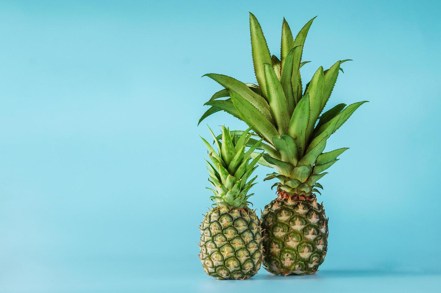 Pineapple fruit isolated on blue background. photo