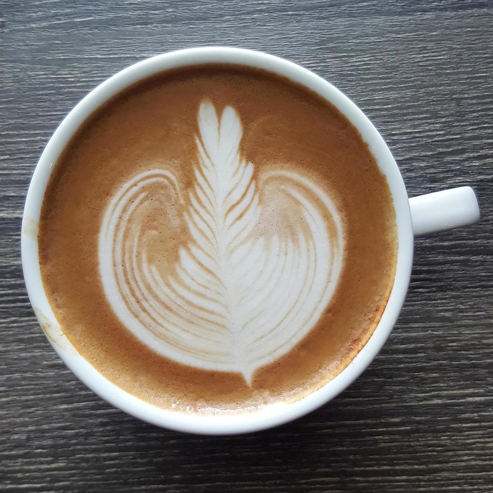 Top view of a mug of latte art coffee. photo