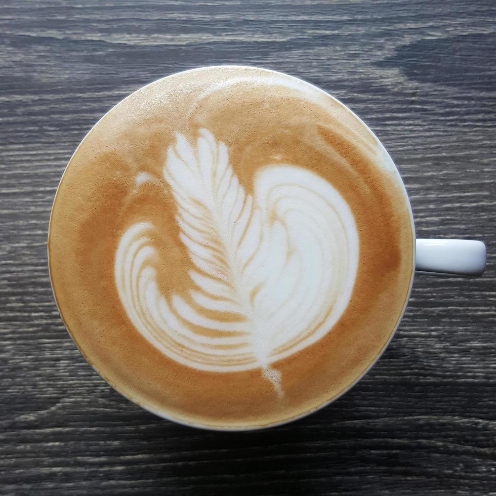 Top view of a mug of latte art coffee. photo