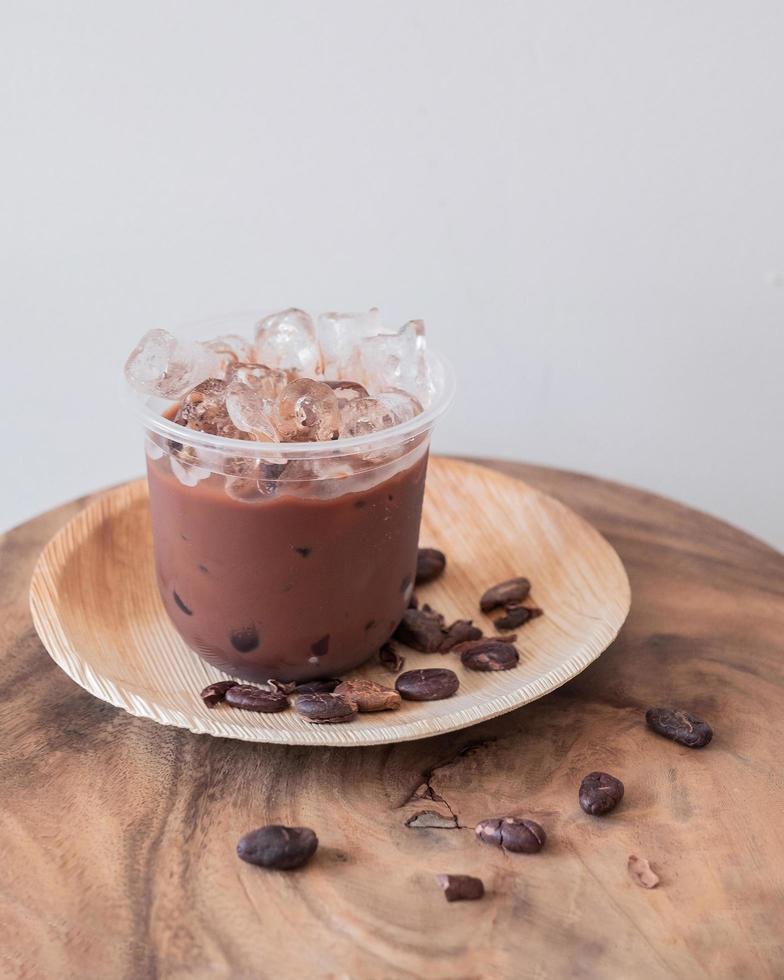 Ice chocolate drink with foam and cacao beans photo