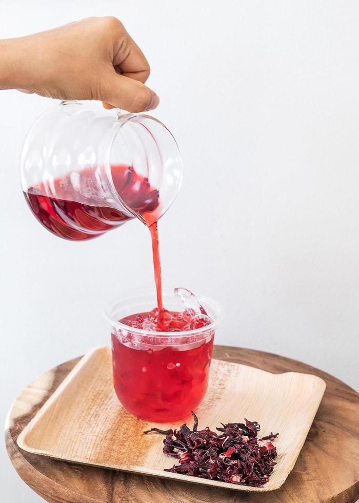 Ice roselle juice isolated on wooden tray photo