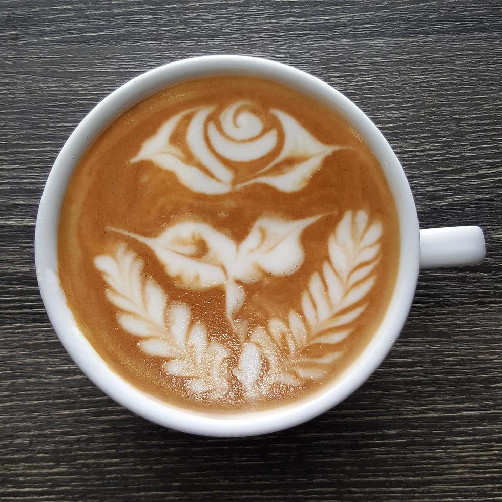 Top view of a mug of latte art coffee. photo