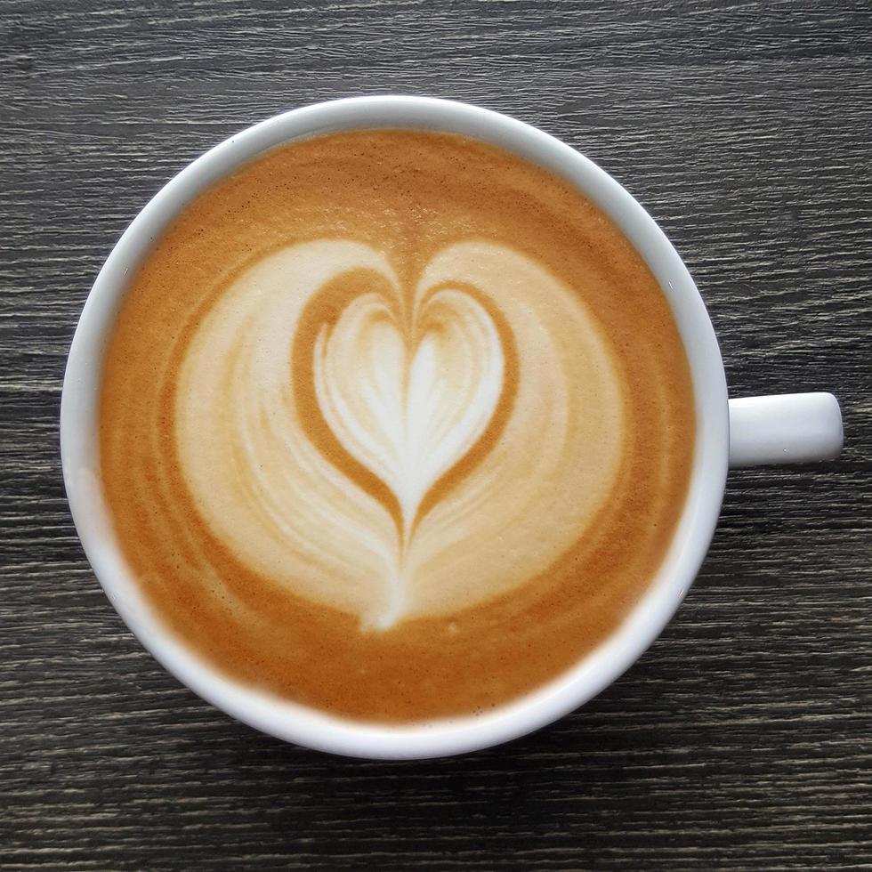 Top view of a mug of latte art coffee. photo