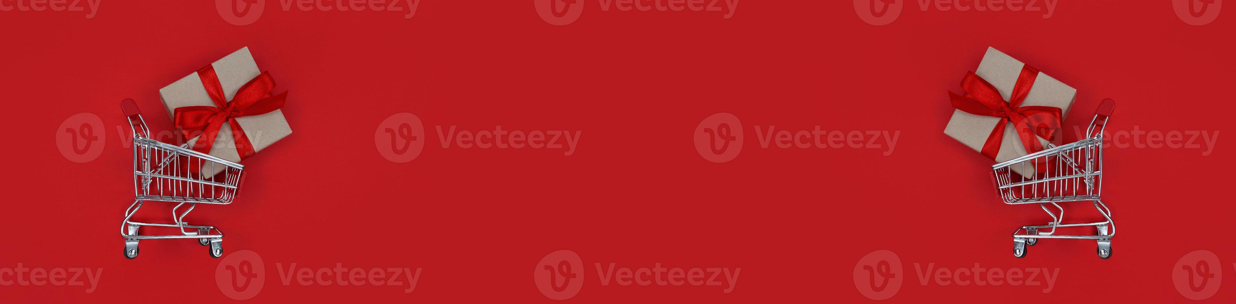 Supermarket trolleys and gift boxs on red background with copy space photo