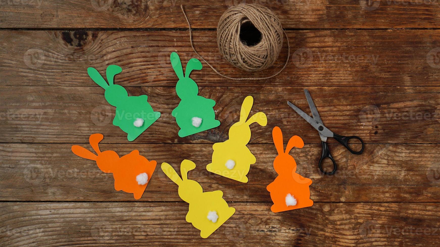 Easter bunnies made of paper on a wooden photo