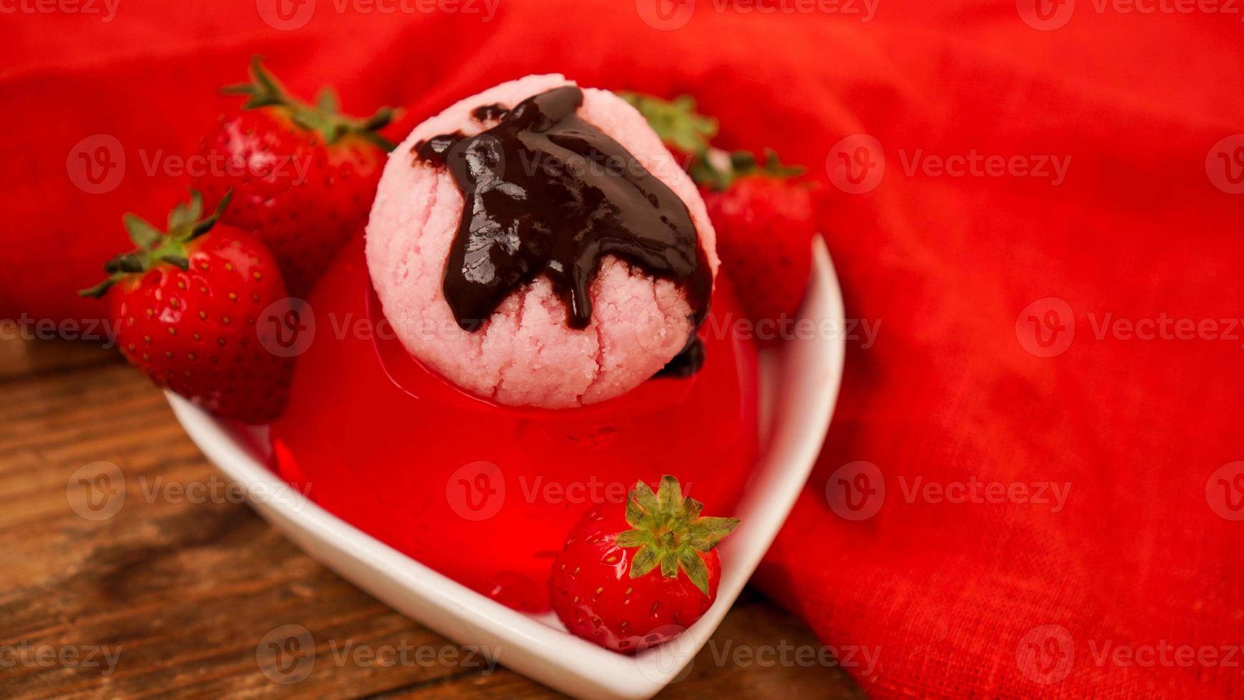 Strawberry jelly in a bowl, decorated with homemade ice cream photo