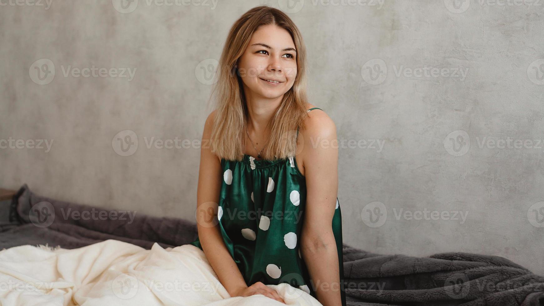 Beautiful smiling blonde in green pajamas. Good morning concept photo