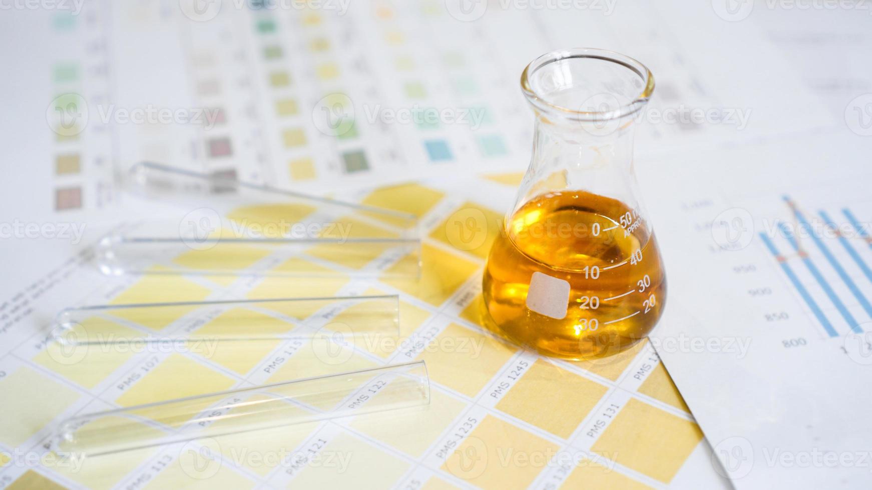 Flask and test tubes with urine on medical color schemes. photo