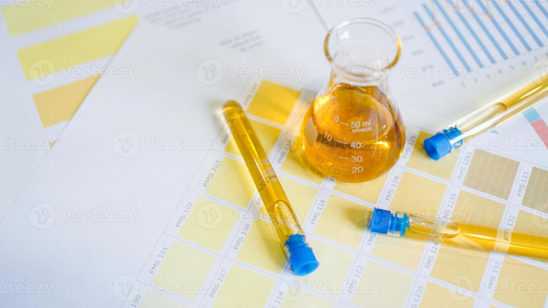 Flask and test tubes with urine on medical color schemes photo