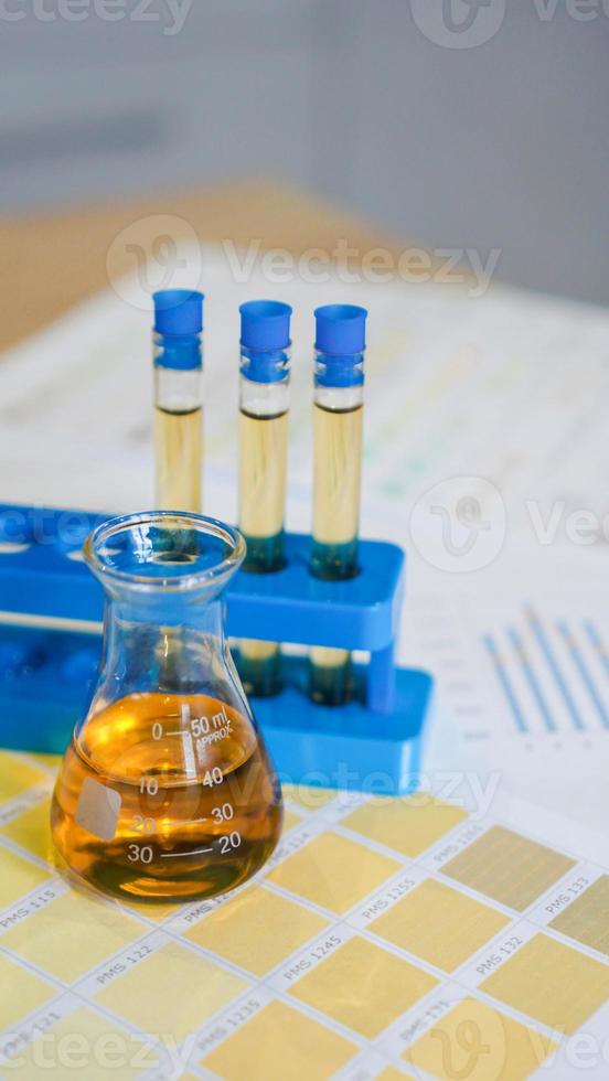 Flask and test tubes with urine on medical color schemes photo