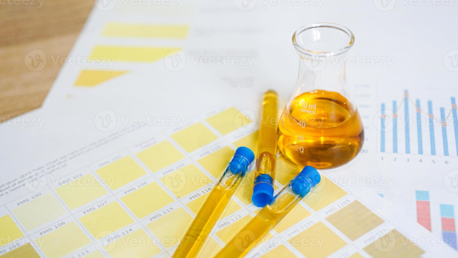 Flask and test tubes with urine on medical color schemes photo