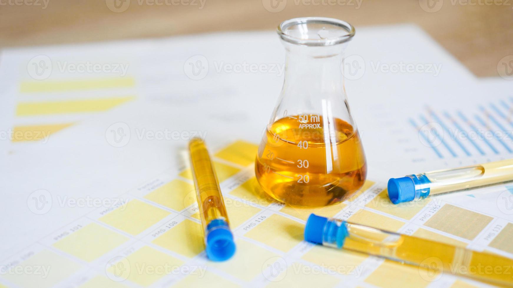 Flask and test tubes with urine on medical color schemes photo