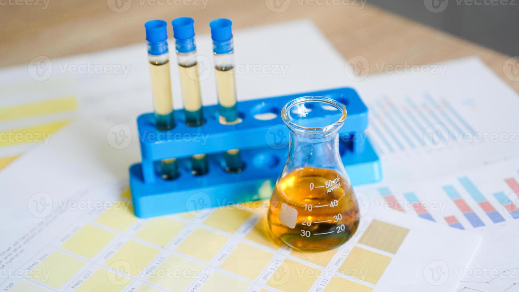 Flask and test tubes with urine on medical color schemes photo