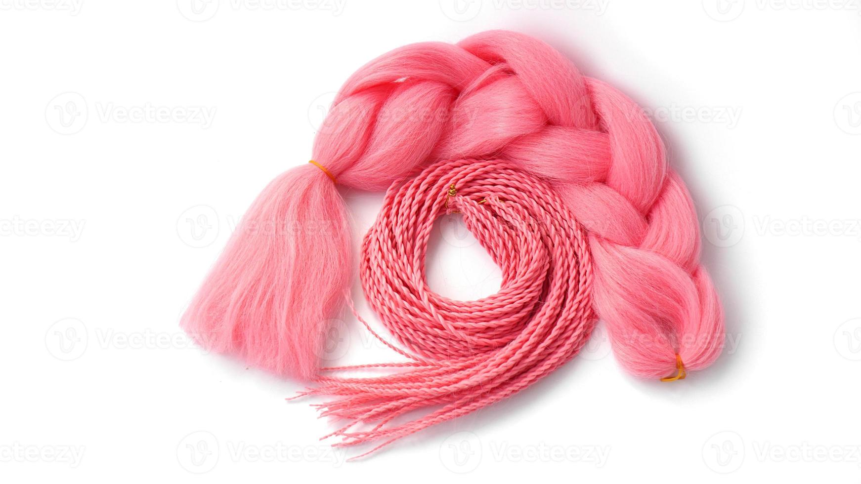 Pink kanekalon hangs on a white background photo