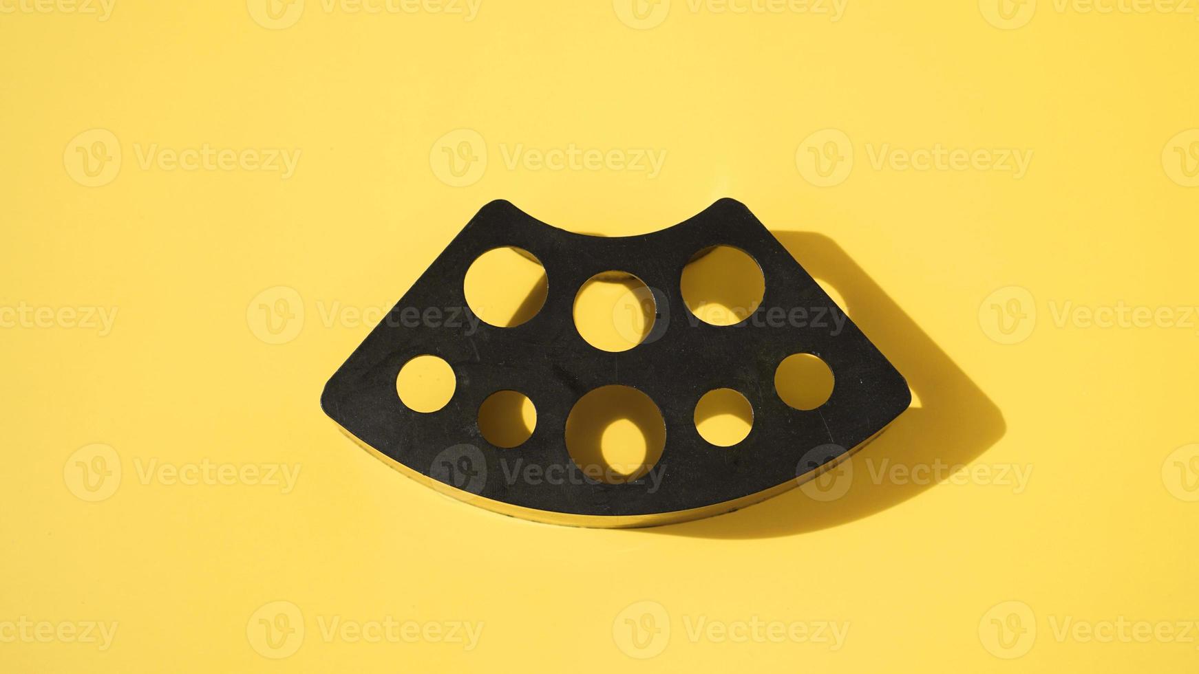 Plastic stand for tattoo ink caps on yellow photo