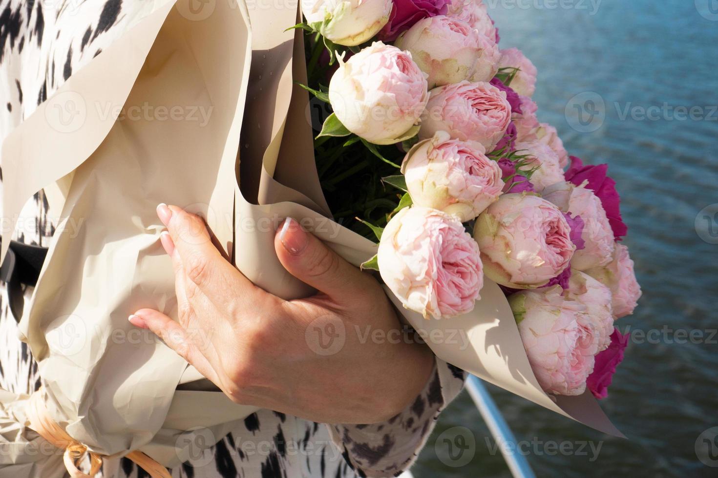 A young girl with a bouquet of bright flowers on a cruise ship photo