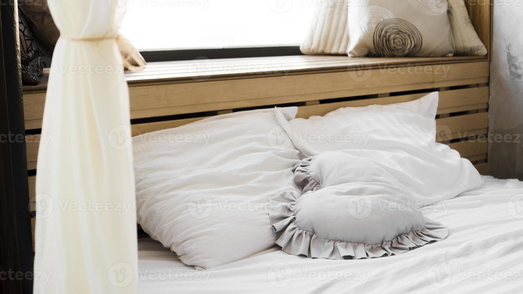 Bed in the bedroom at window with textured coverlets photo