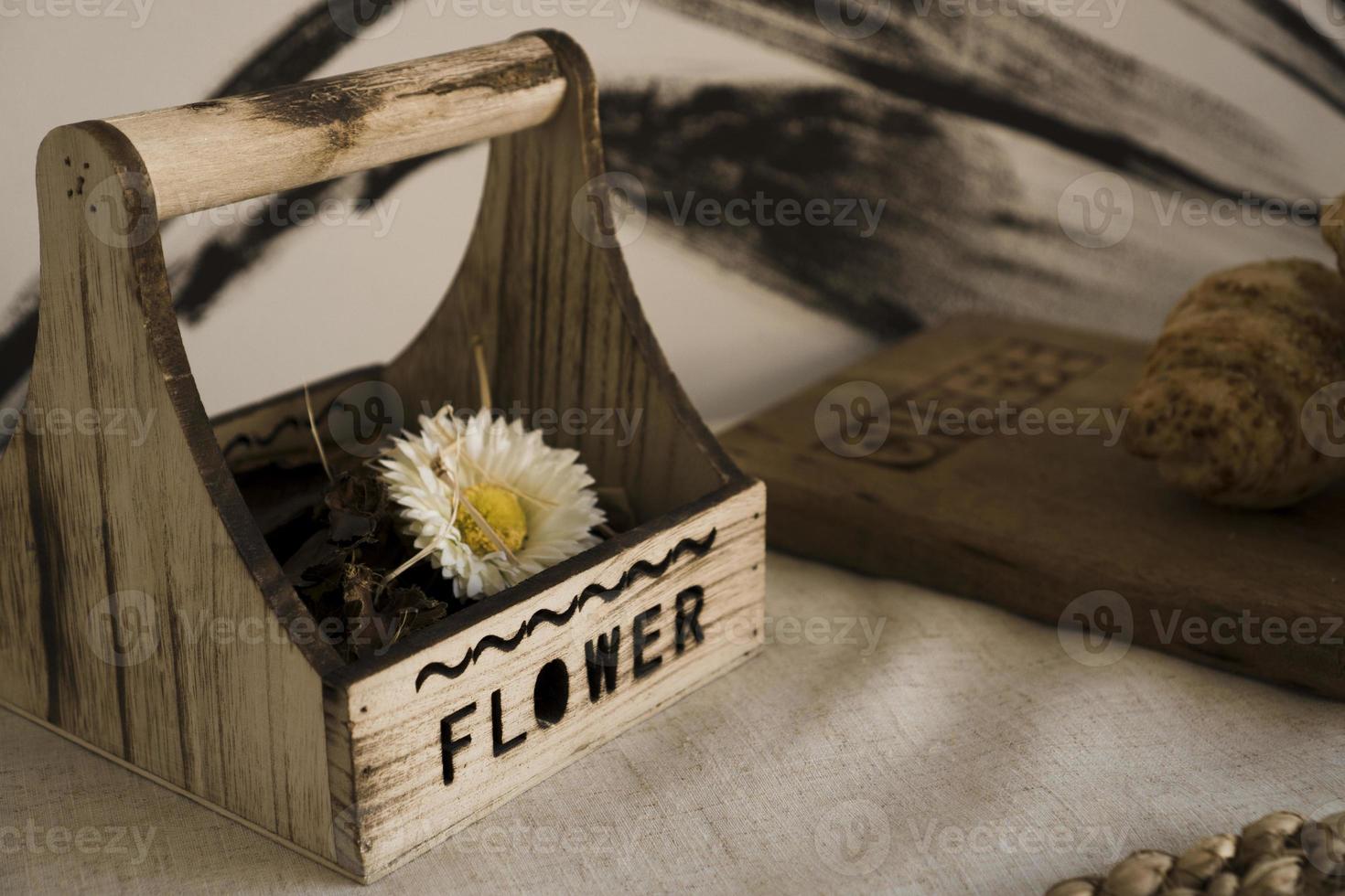 Dried flower in a wooden box on the table. Scandinavian style photo