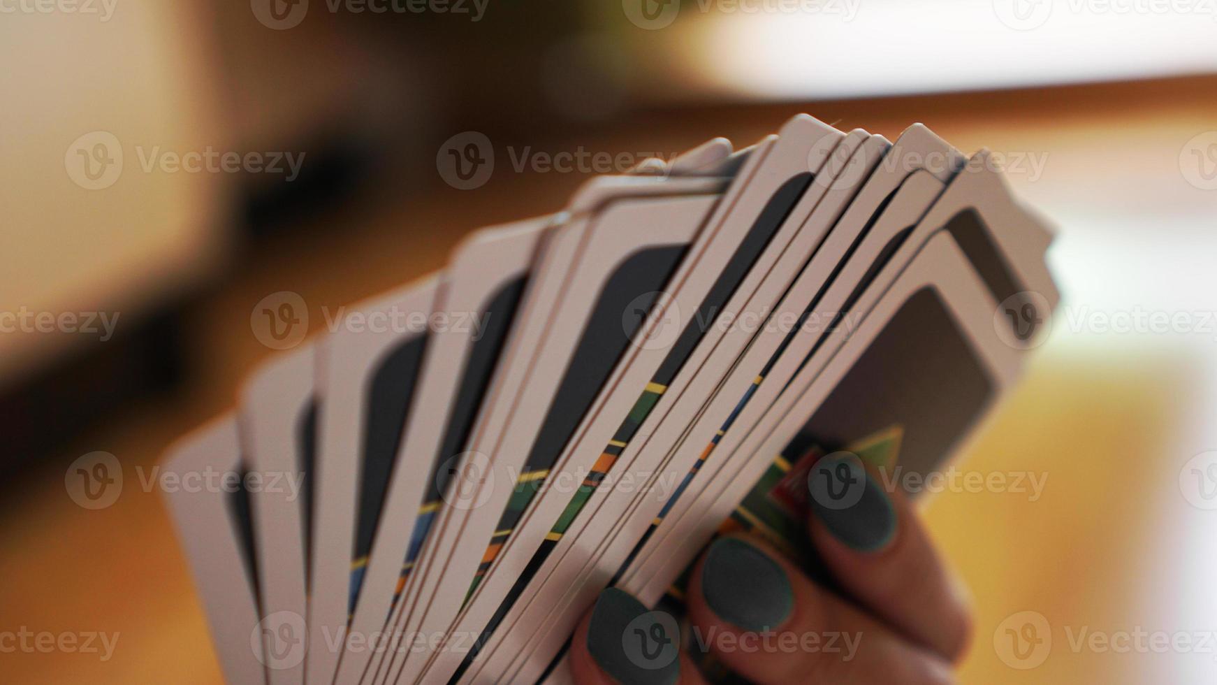 People playing cards. Hand with cards on blurred background photo