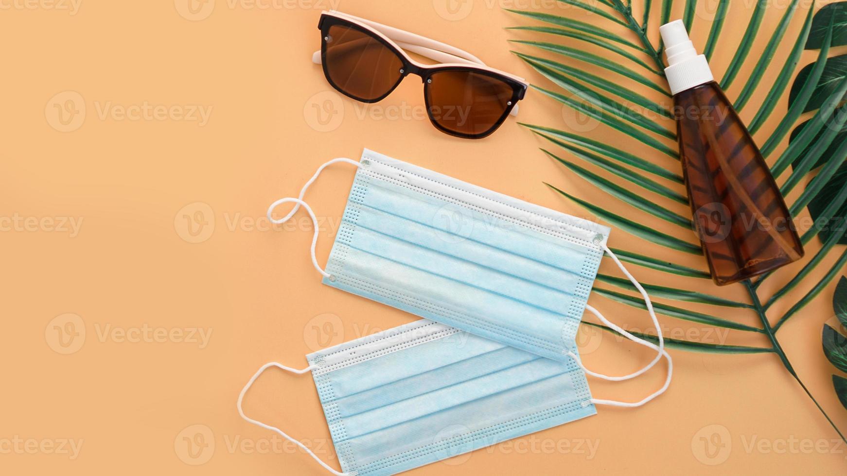 Sunglasses, protection spf cream, medical masks. Beach accessory photo