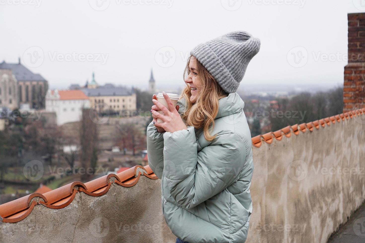 Female tourist against the background of town in the Czech photo