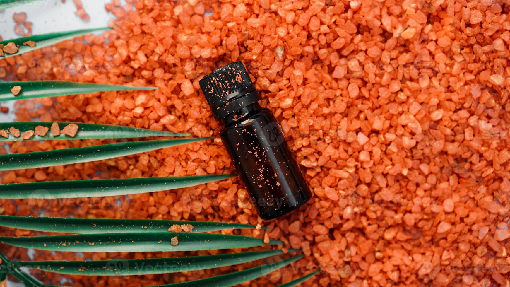 Cosmetic bottle with oil on a background of sea salt photo