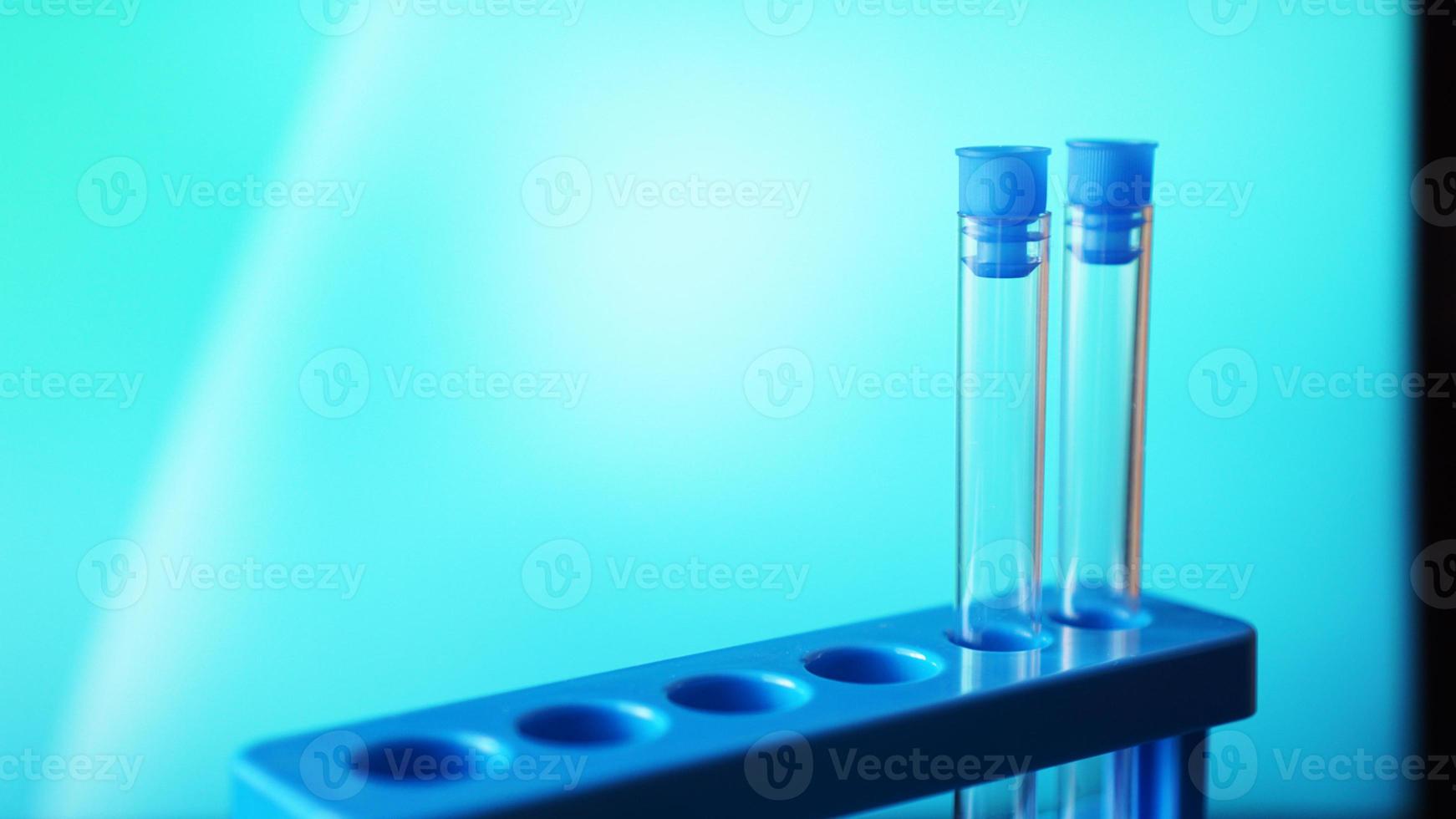 Test-tubes on a blue stand against blue background photo