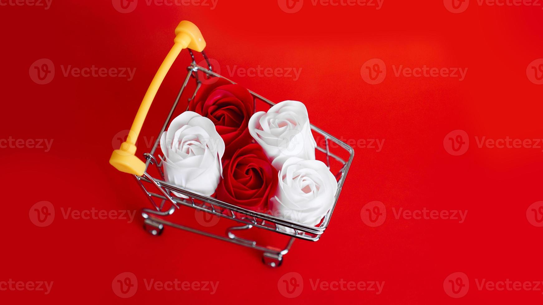 Red and white roses flower on shopping cart photo