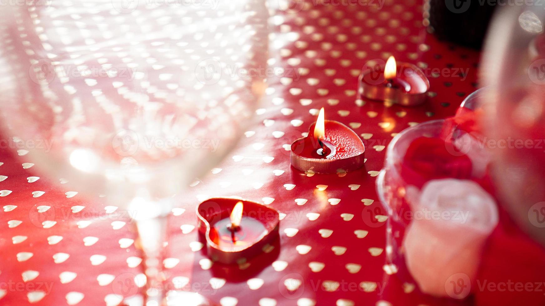 Candles for valentines day, table with festive red background photo