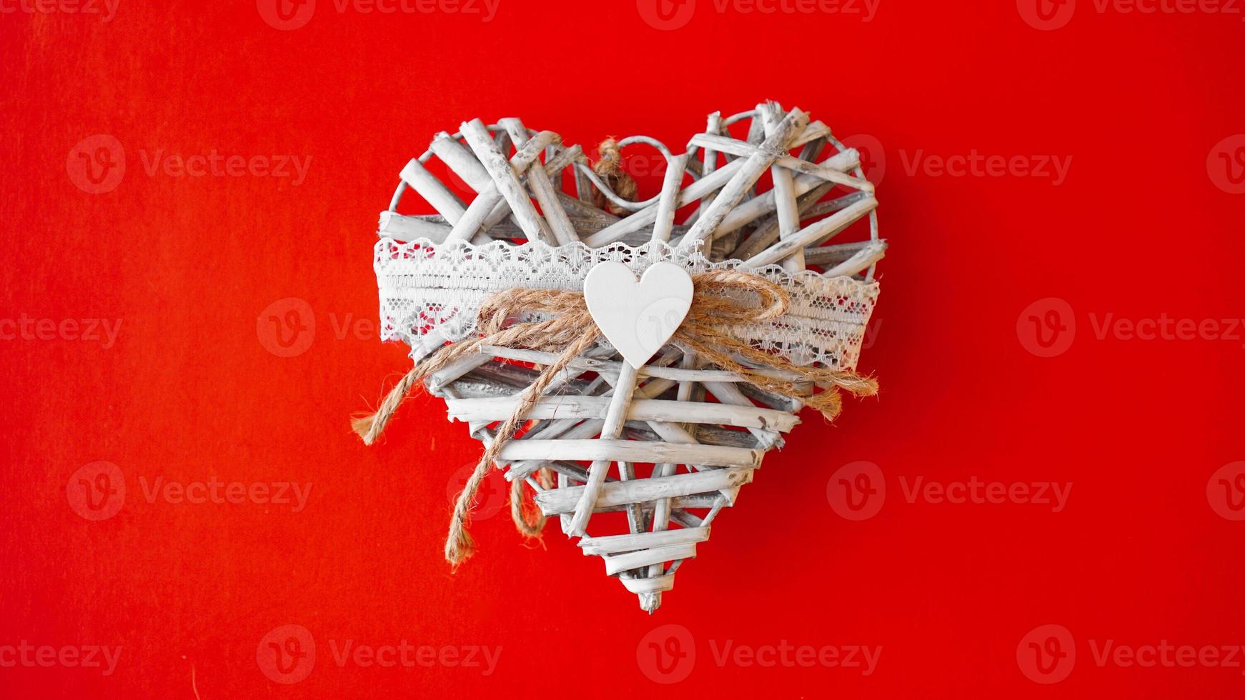 White hand made heart on red background photo