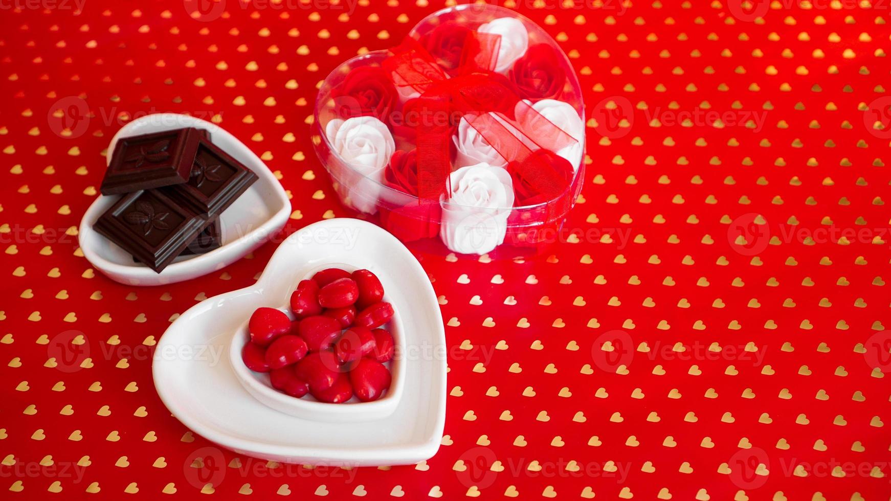 Chocolate candies in heart shaped plate photo