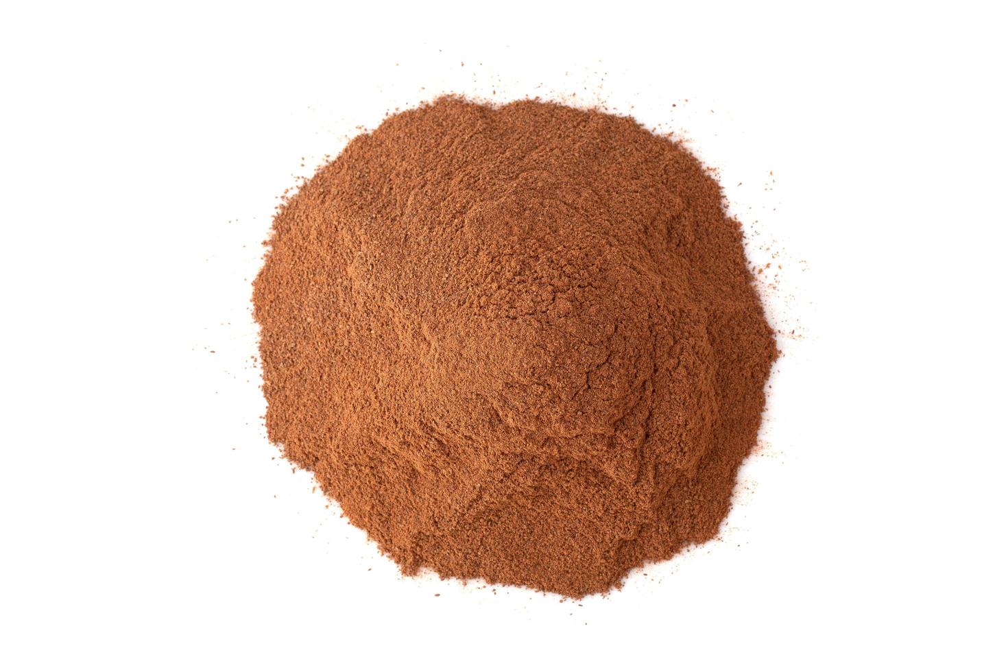 Pile cinnamon powder isolated on white background photo