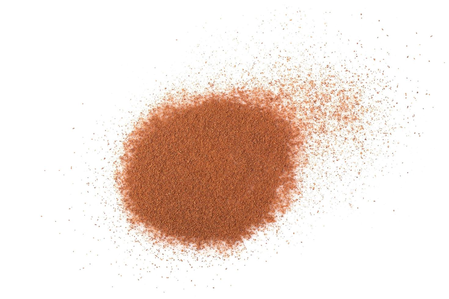 Pile cinnamon powder isolated on white background with top view photo