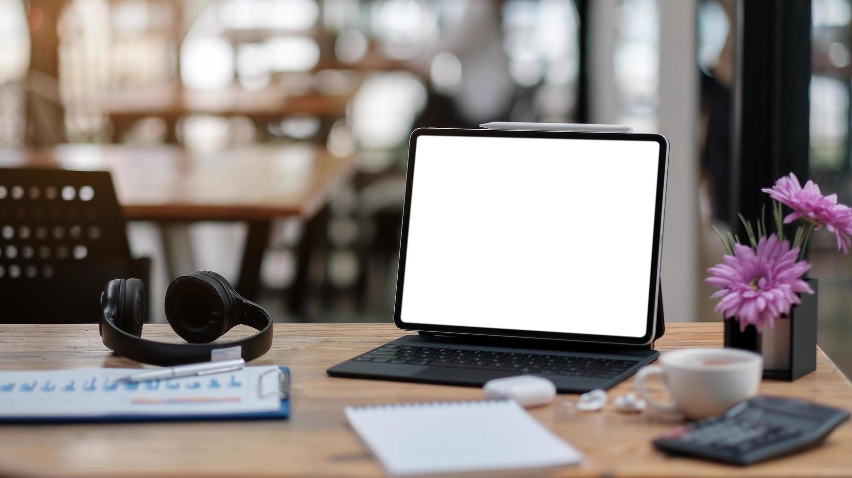 Computer laptop with blank screen on table of coffee shop photo