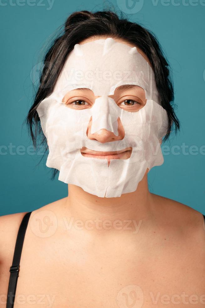 Happy plus size girl doing full split. skin care photo