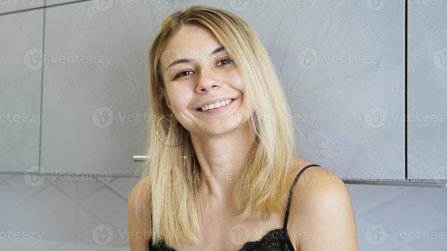 Cheerful young female smiling and looking at camera photo