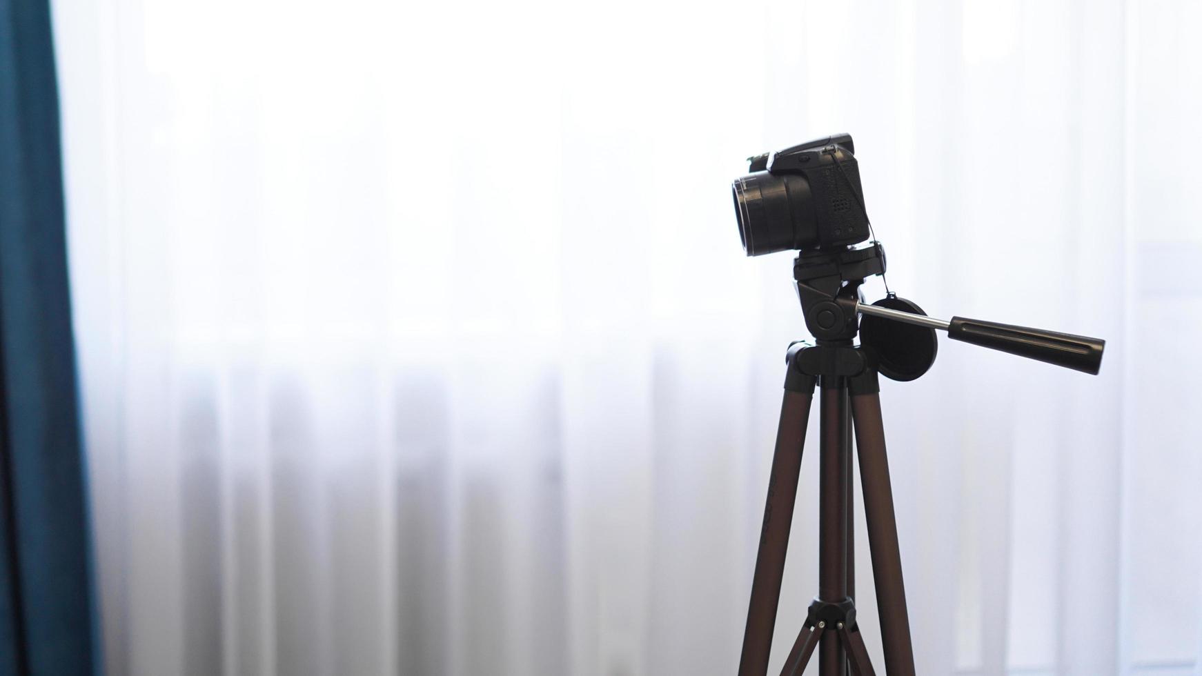 Camera on a tripod indoors. Filming a video blog photo