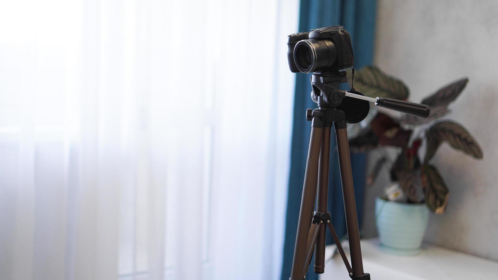 Camera on a tripod indoors. Filming a video blog photo