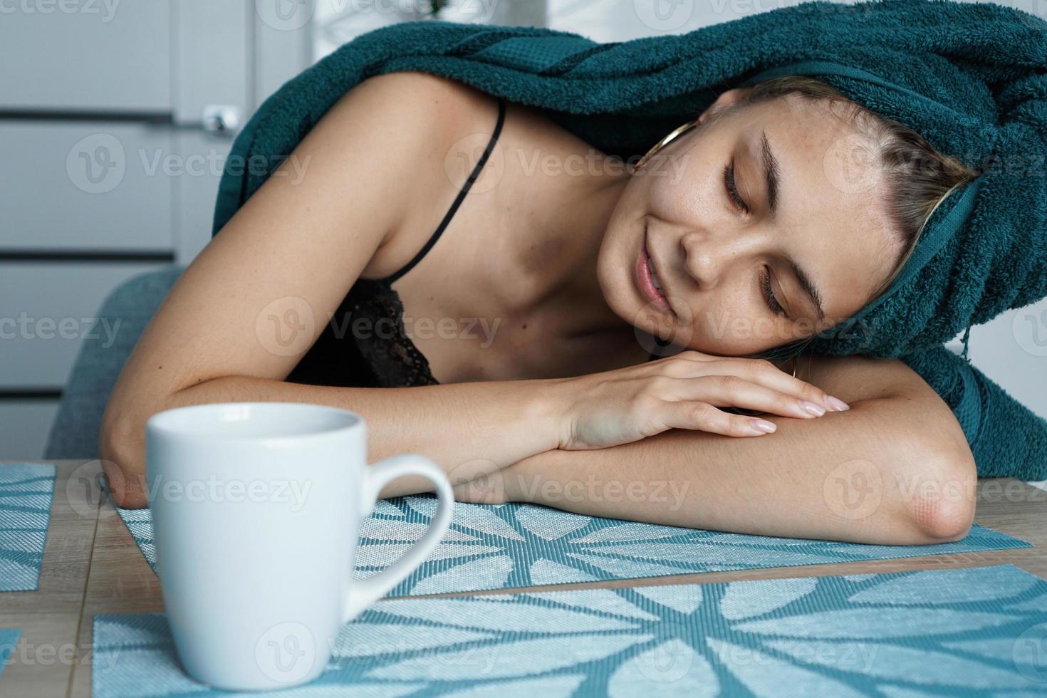 Tired woman sleeping on the table. Lazy sleepy morning photo