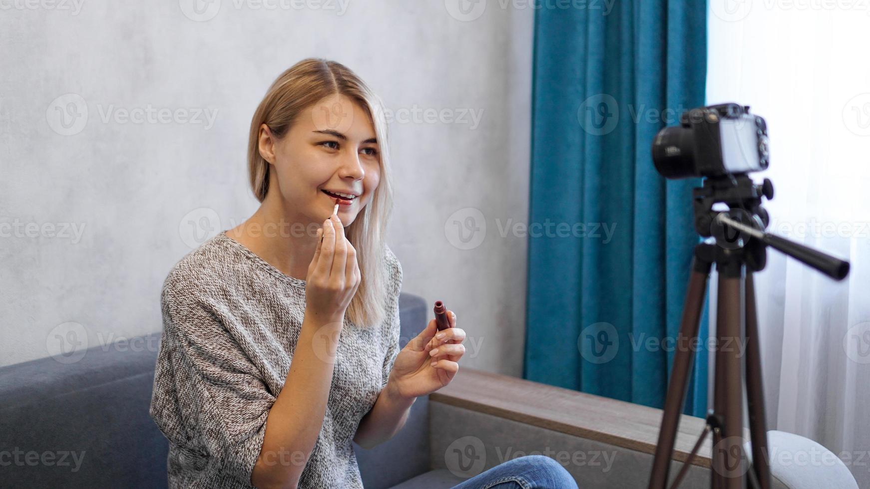 A beauty blogger or video blogger tells and shows how to do makeup photo